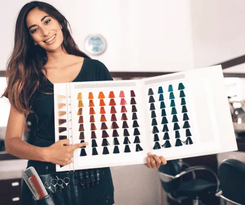 Hairstylist with book of hair swatches.